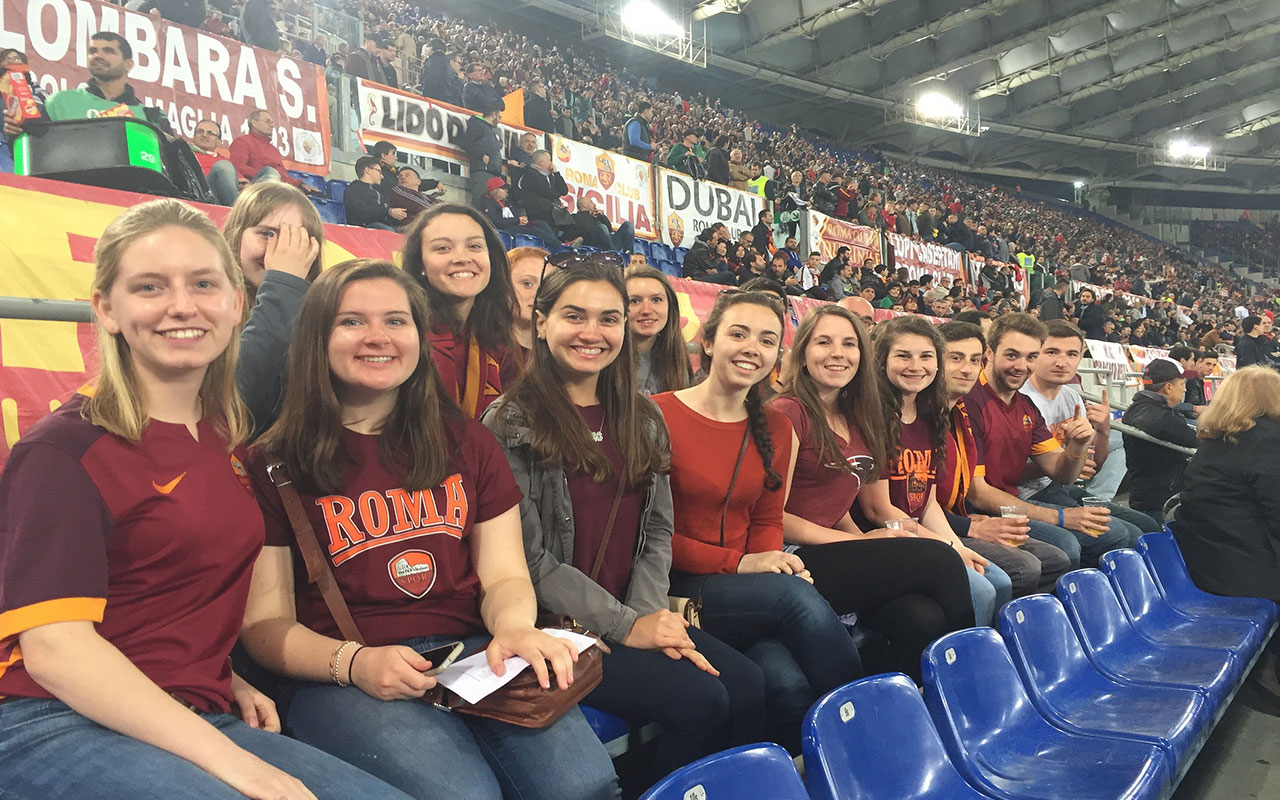 Assumption students enjoy a Roma football game in their downtime.
