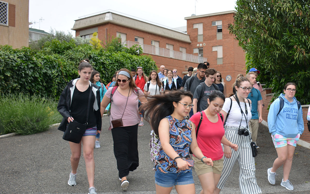Assumption students walking down the driveway that leads to the College's campus in Rome. 