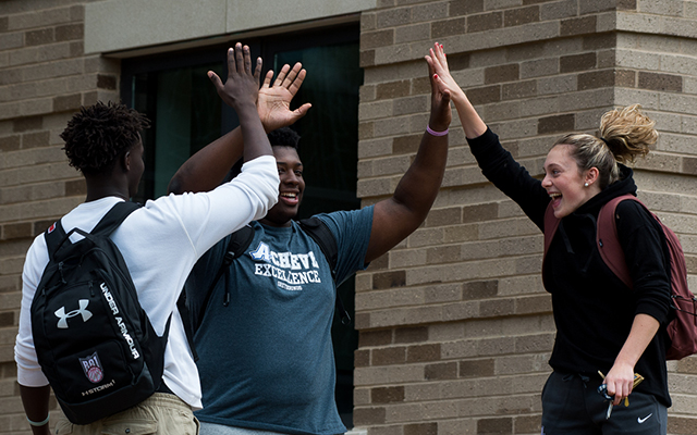 students high-fiving