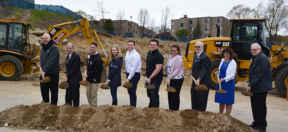 Assumption Faculty, Staff, and Students turning the dirt at the Health Sciences groundbreaking event.