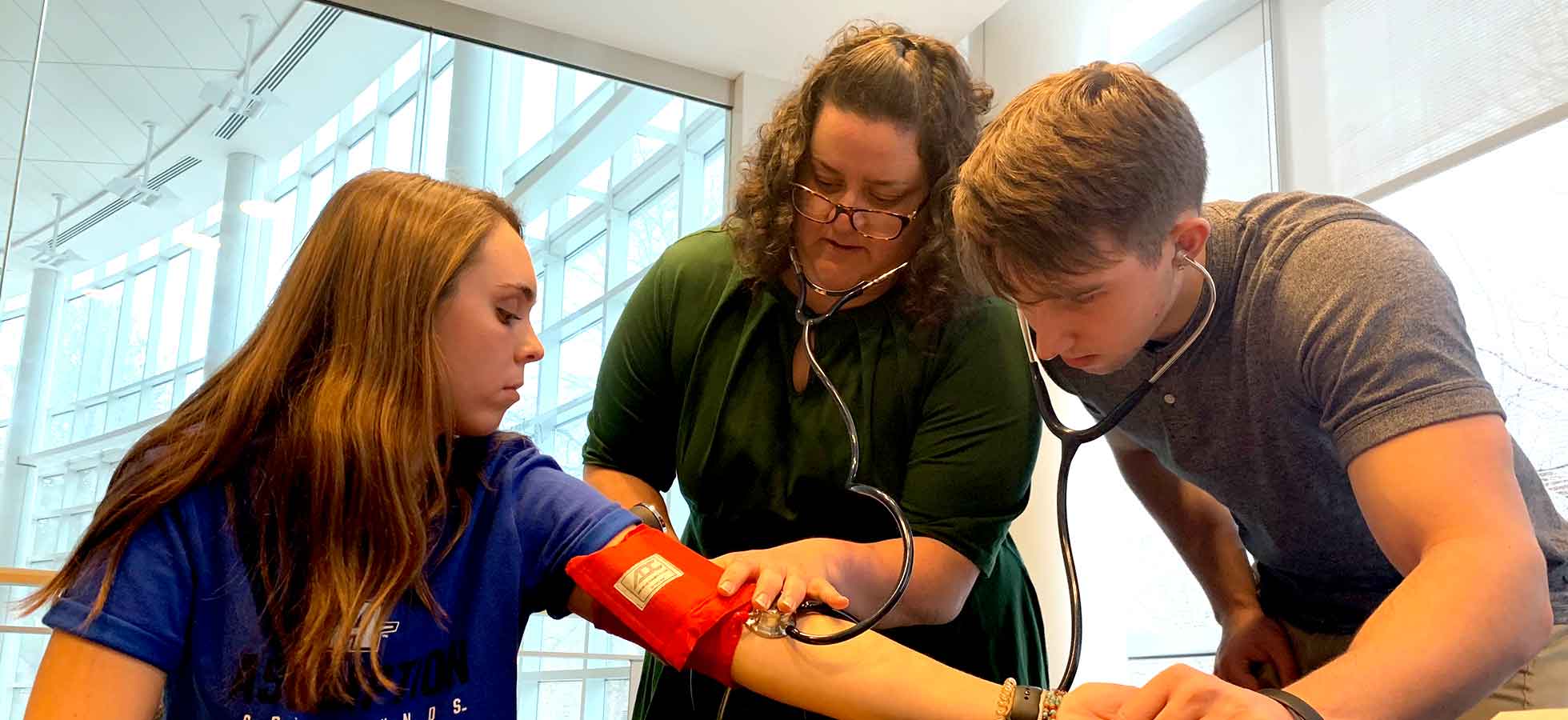 nursing students taking blood pressure