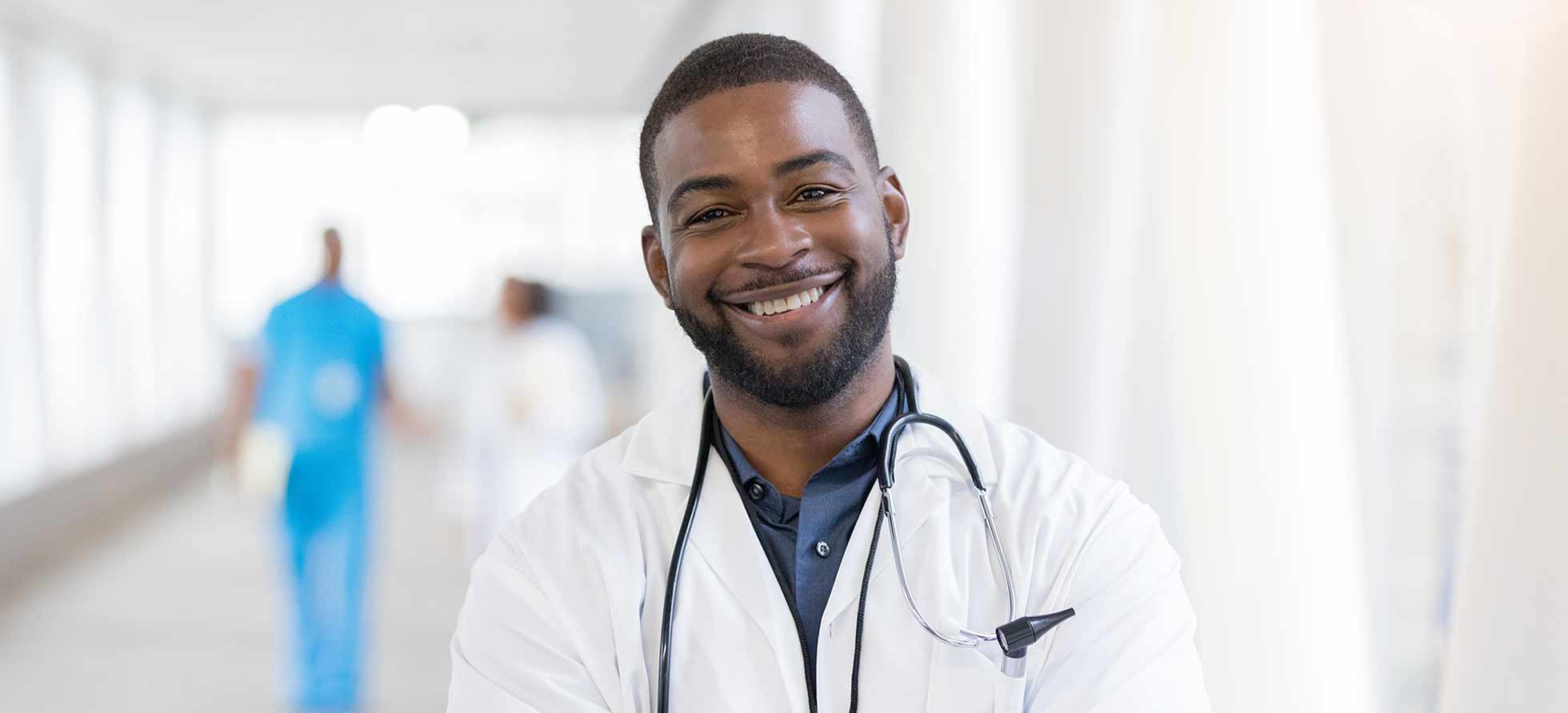 physician assistant standing in hallway