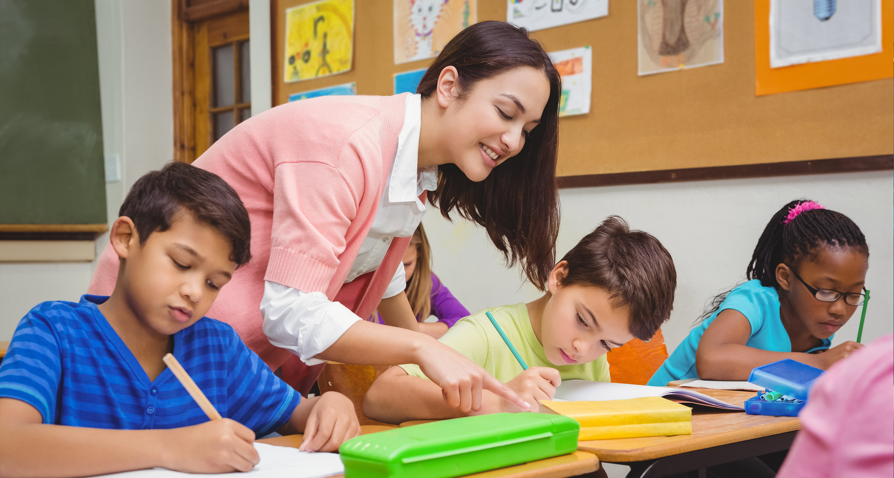 A teacher working with her students in a classroom. Assumption offers a program in Special Education: Autism Spectrum Disorders C.A.G.S. (with Endorsement)