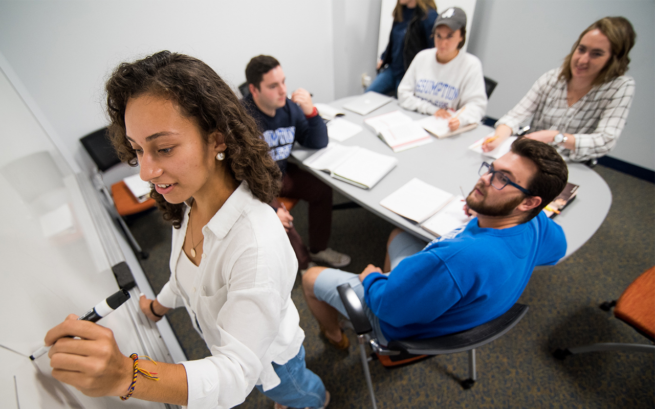 A group of Assumption University students using one of several study rooms in the d'Alzon Library on campus.