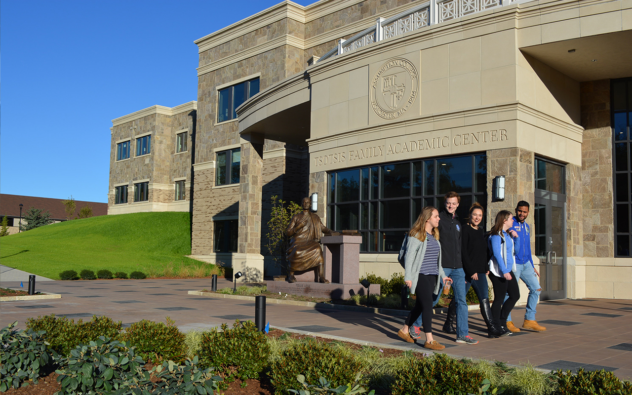 A group of Assumption University students walks by the Tsotsis Family Academic Center, an academic building on campus.