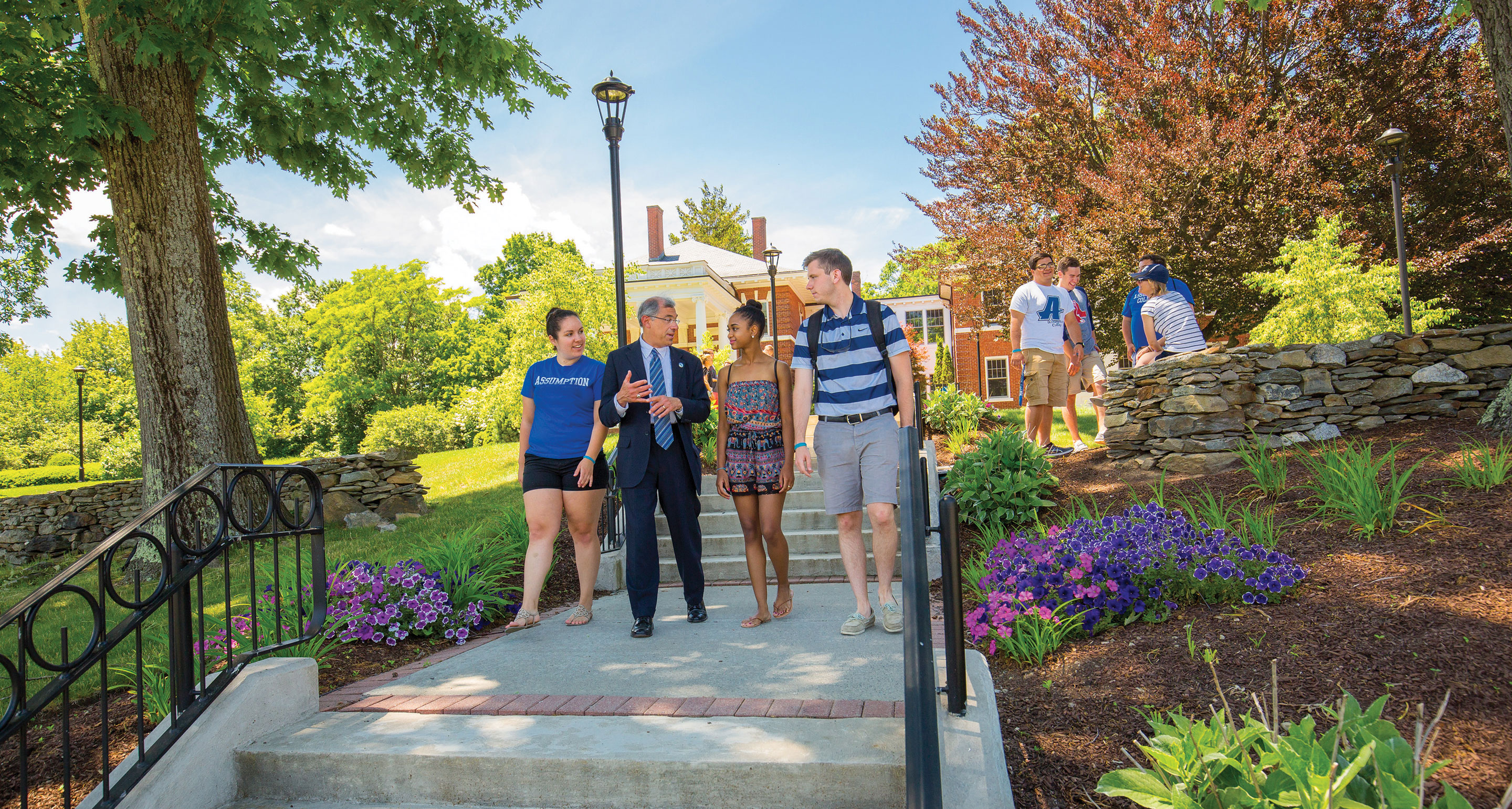 Students Walking Outside with President Cesareo