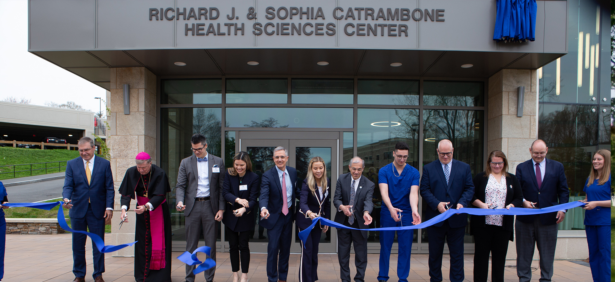Assumption University leaders and members of the Catrambone family cut the ceremonial ribbon for the new Health Sciences Building. 