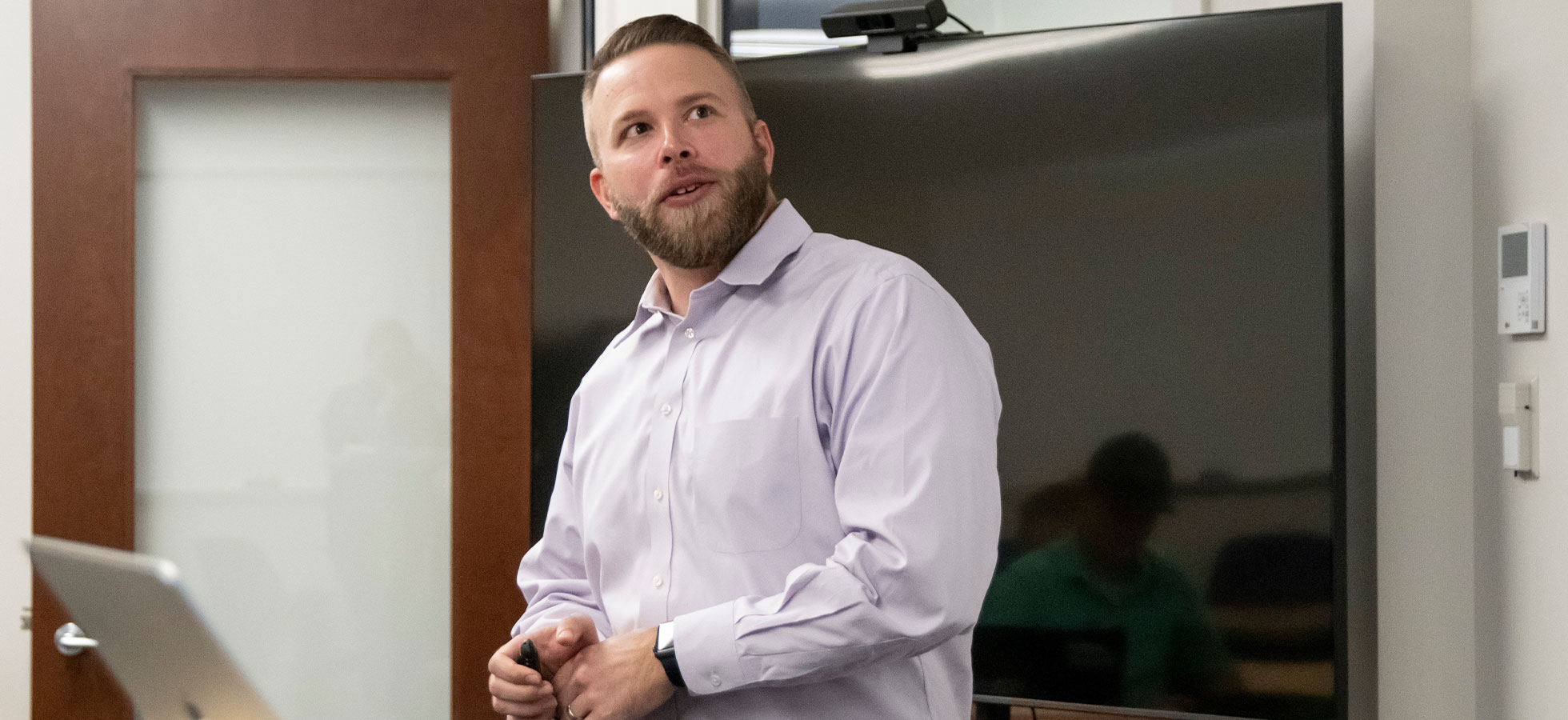 Assumption University Professor Zach Daniels teaching Digital Marketing skills in a classroom.
