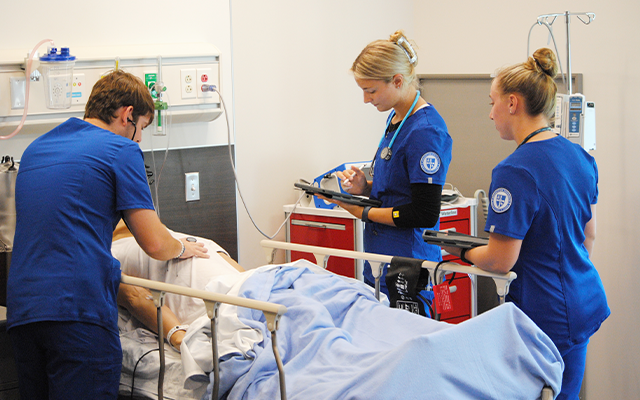 Nursing students working in simulation lab