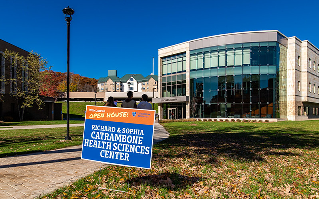 Photo of Catrambone building with an Open House sign on the path to the building