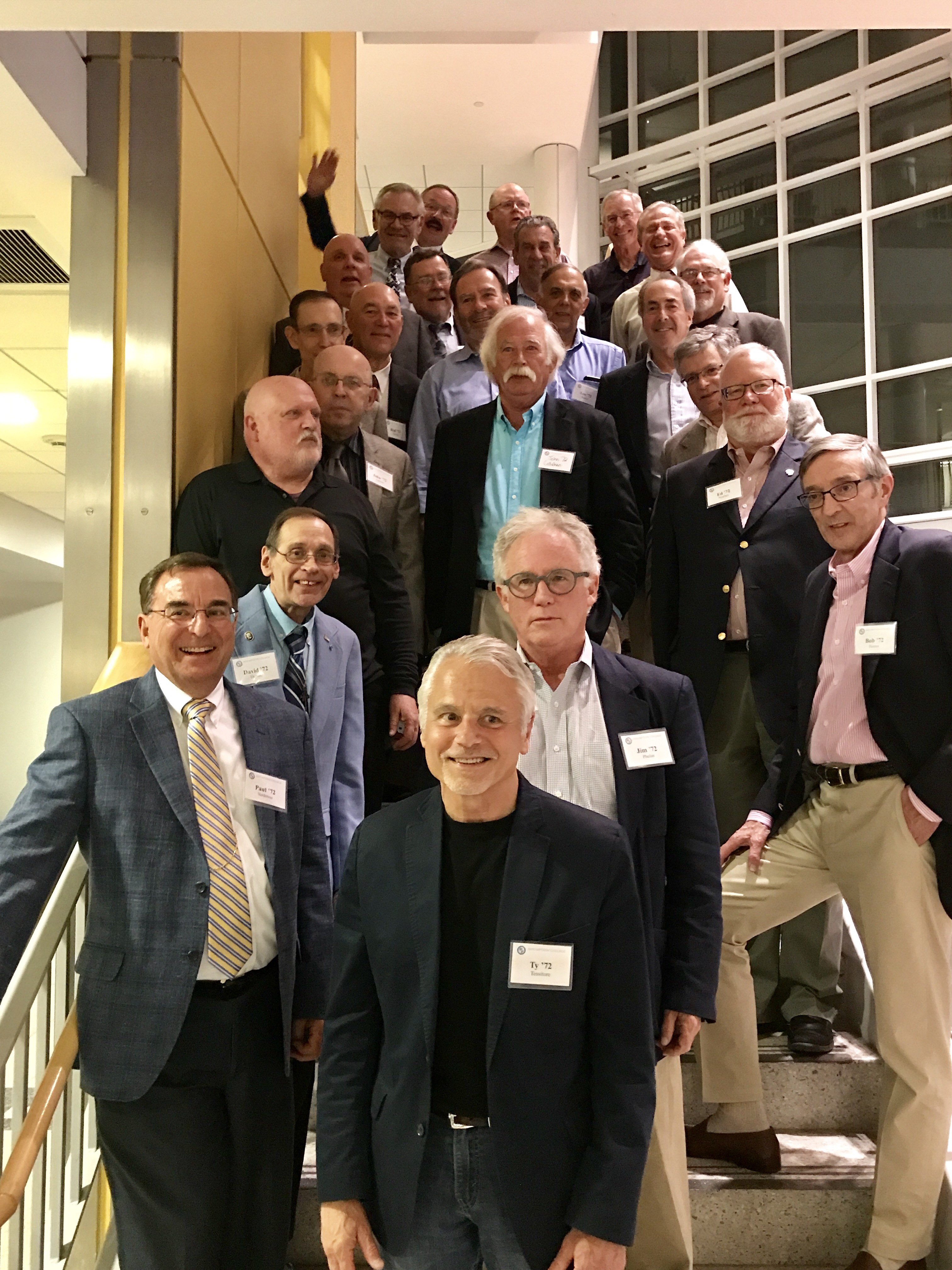 Members of the Assumption College Class of 1972 standing on the stairs in the Testa Science Center.