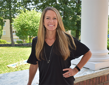 Photo of Marci Mayo on the porch of the Admissions House
