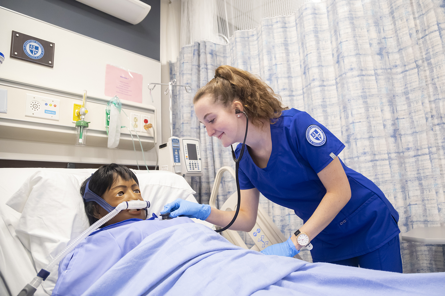 Nursing student working with a patient.