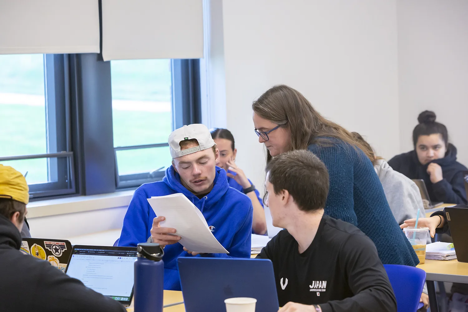 Professor helping a student during class