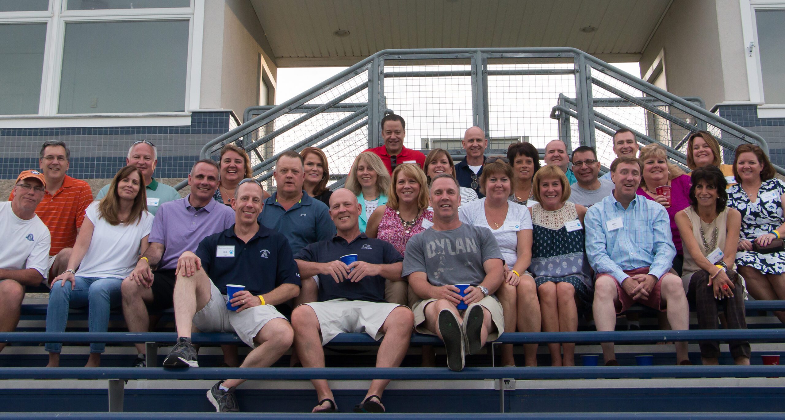 Assumption College alumni pose during Reunion Weekend at the Multi-sport Stadium.