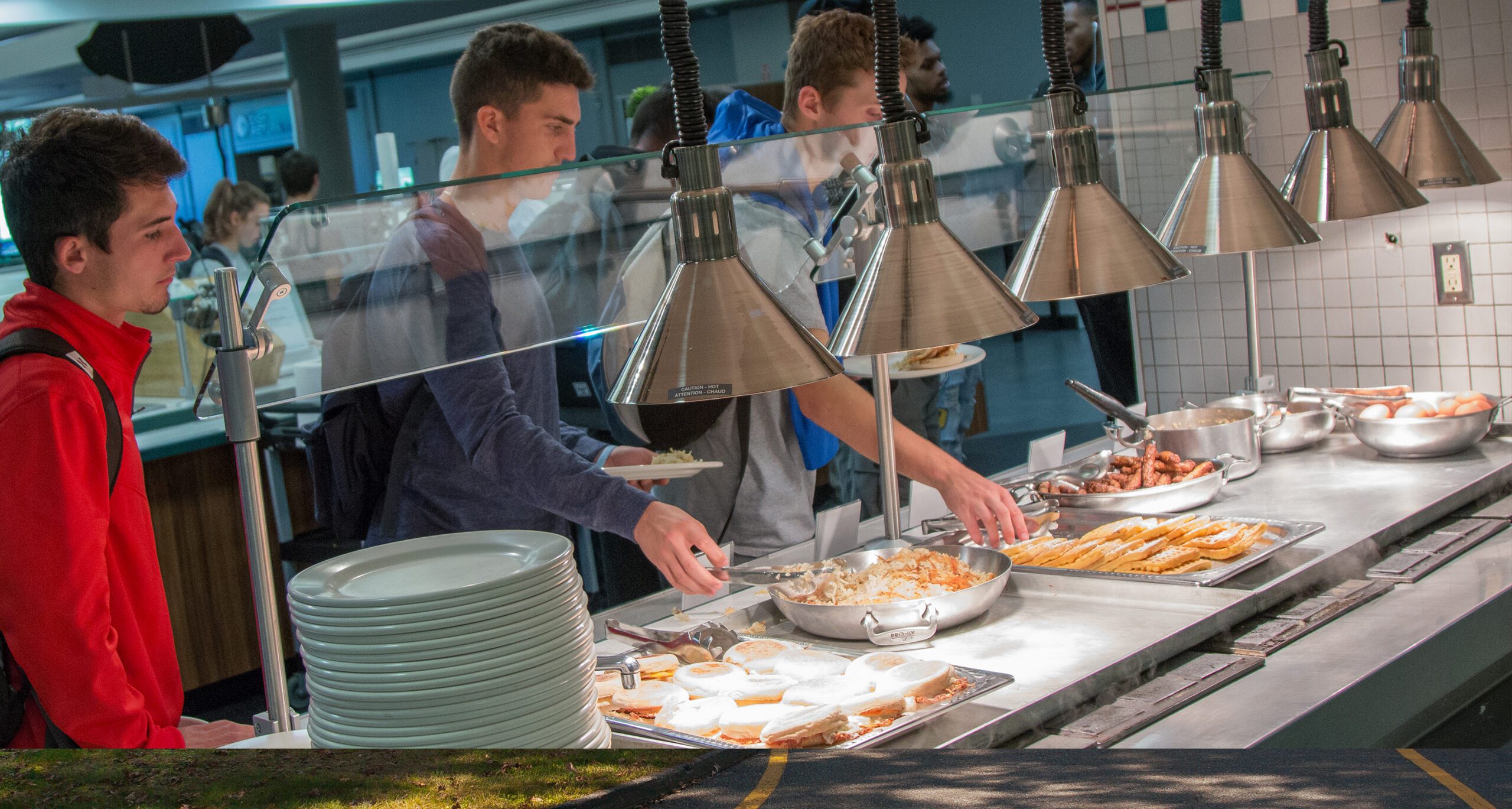 Assumption students selecting from a variety of delicious food at Taylor Dining Hall.