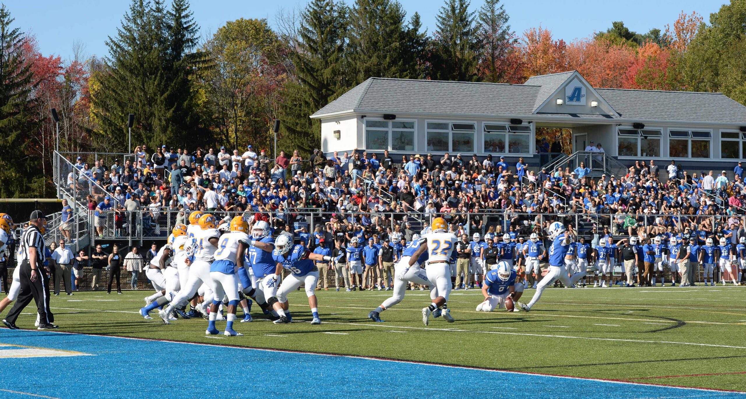 Assumption University football players line up to kick an extra point during a home game in Brain Kelly '83 Stadium