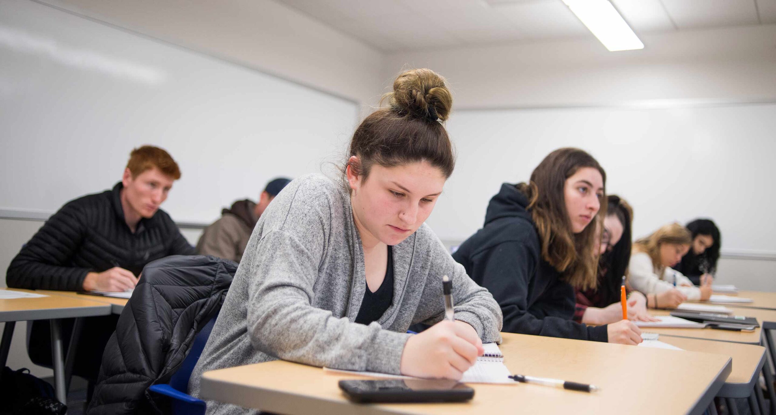 Assumption students write notes during an accounting class