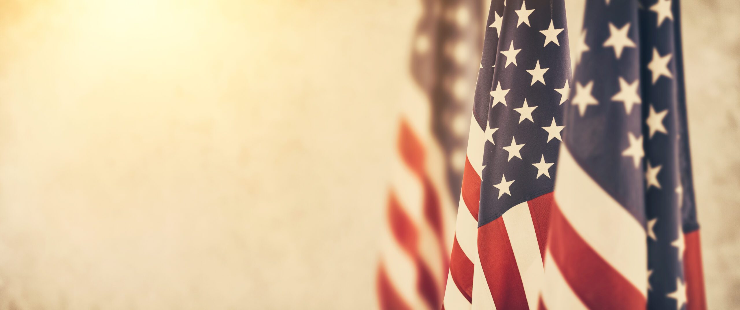 A photo of three U.S. flags hung vertically.