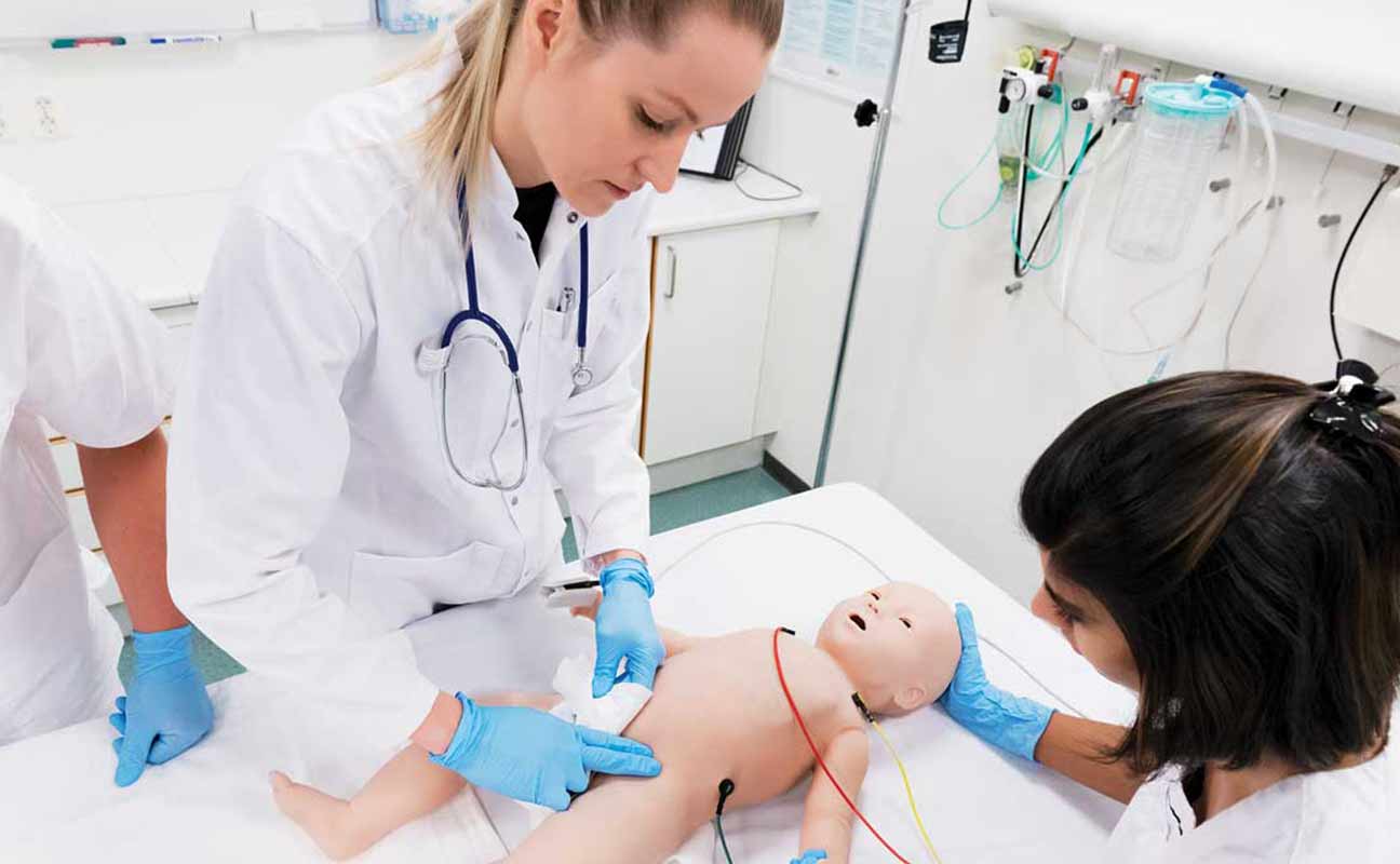 nursing students working on sim baby