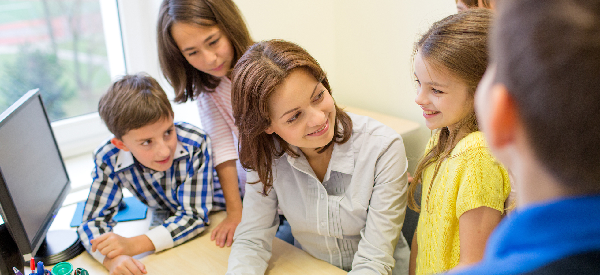 A photo of a teacher working with children. Assumption's School Counseling program prepares culturally competent school counselors to lead comprehensive programs that promote and enhance student academic, social and emotional success.