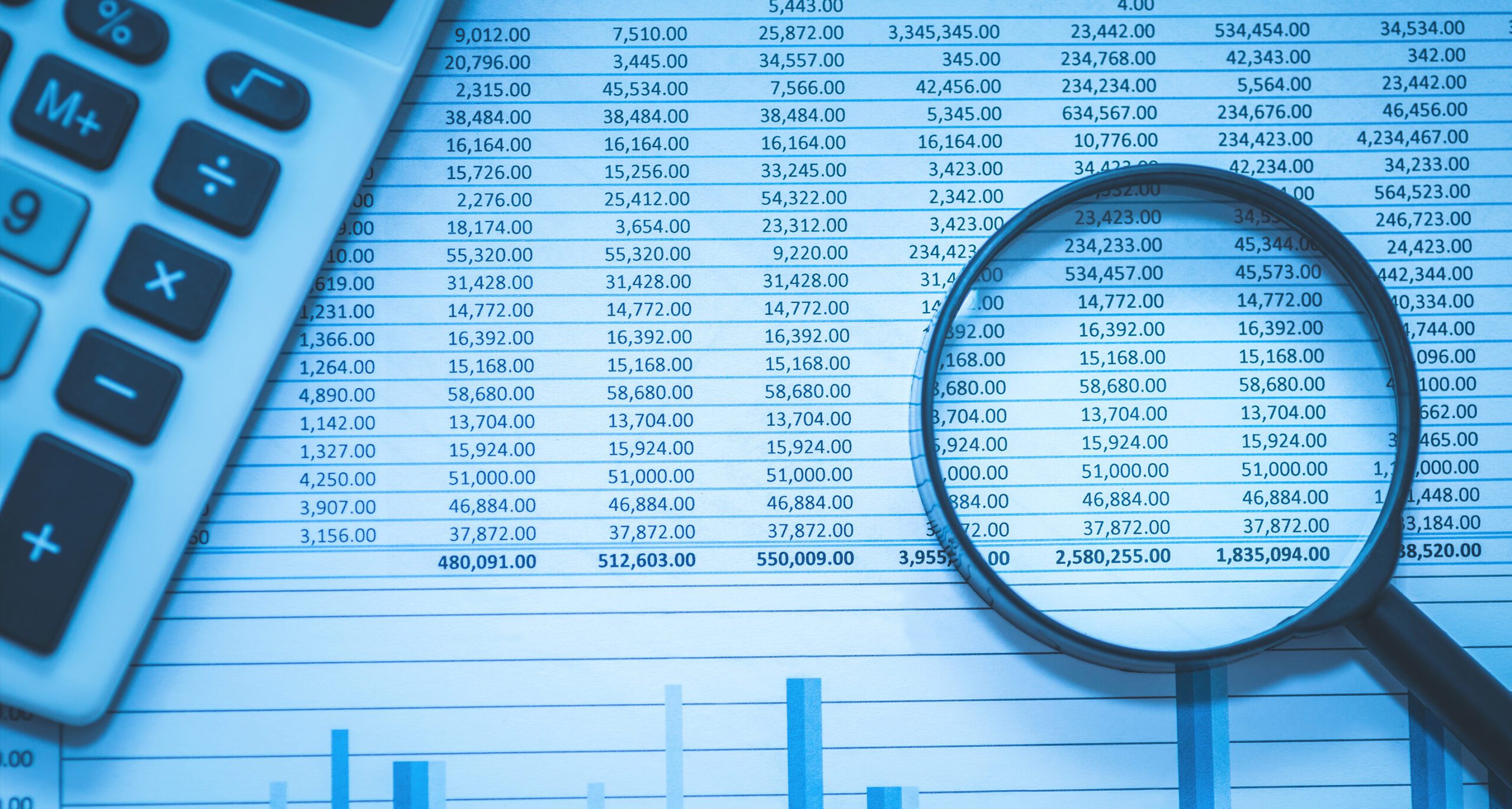 Photo of spreadsheets of bank accounts with a calculator and magnifying glass.