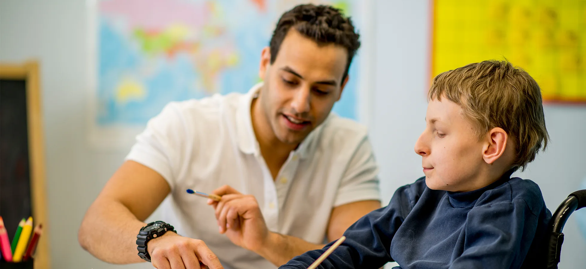 Teacher with a child in a classroom setting. The Assumption ABA program provides opportunities to work with faculty in the psychology, human services and rehabilitation studies, and education departments.