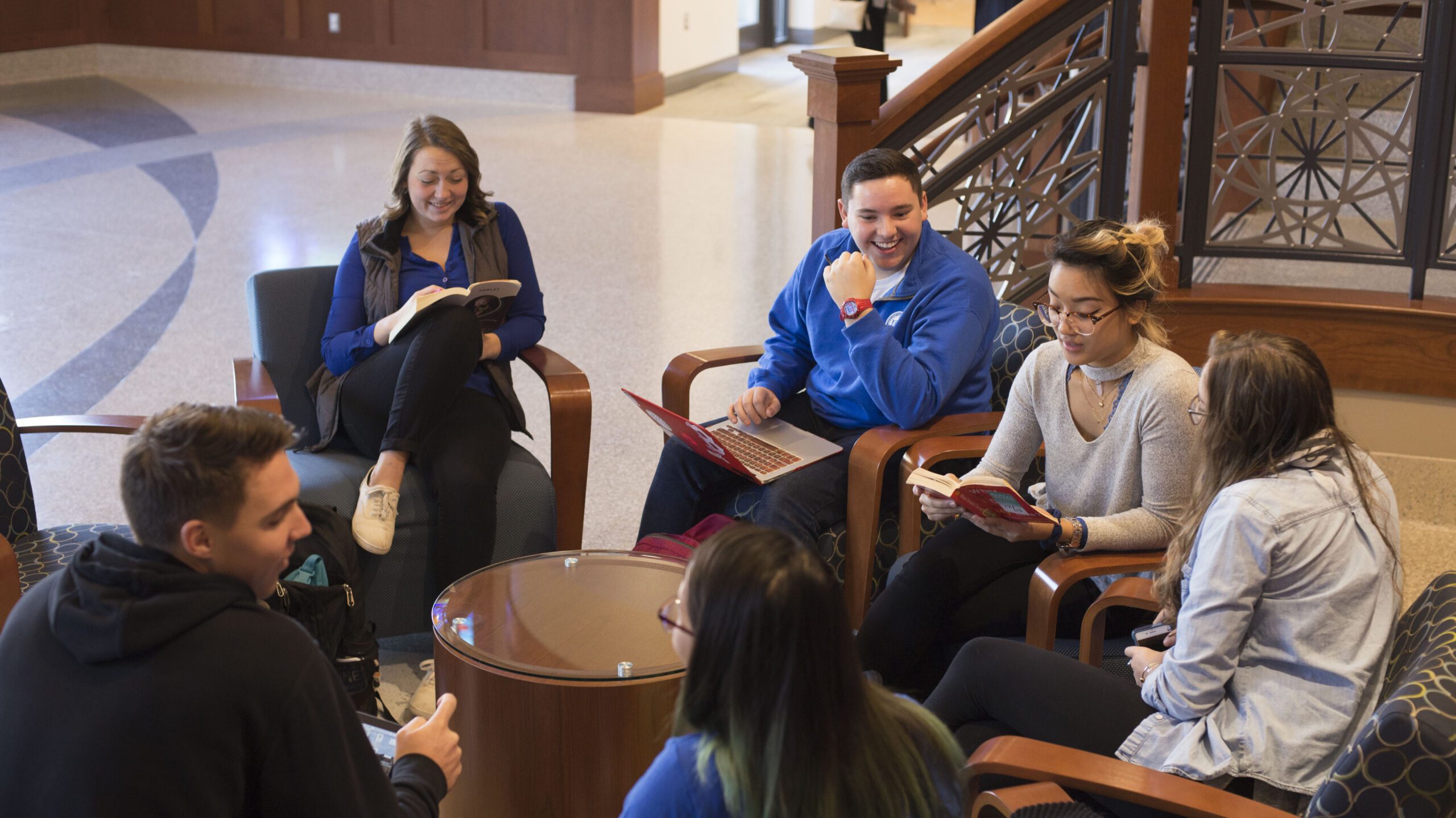 Group of students sitting around a circle table.