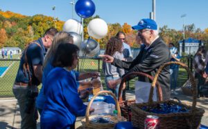 Assumption alumni gathered at an info for table at Homecoming.