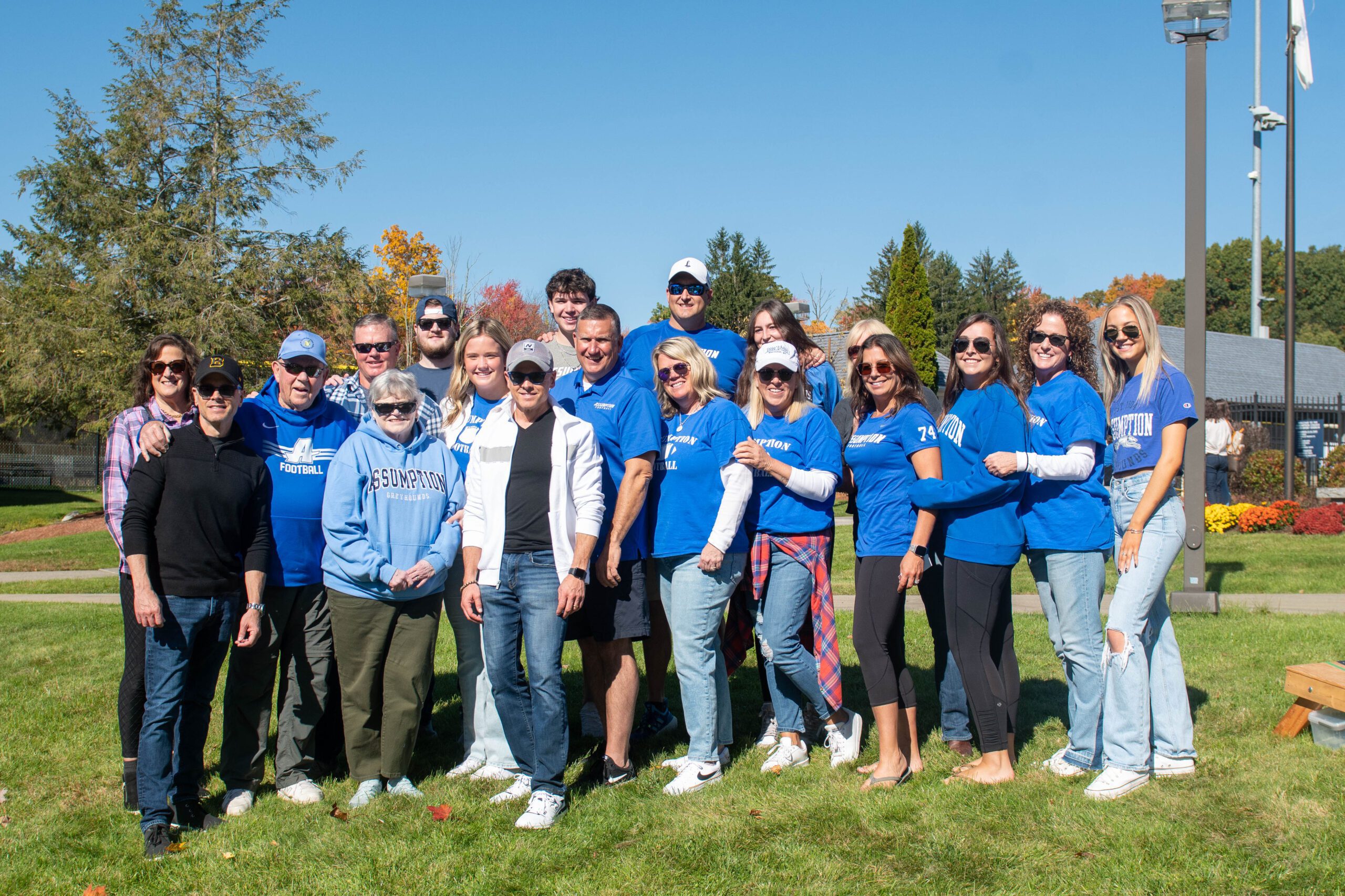 Group of alumni in Assumption blue posing for a picture.