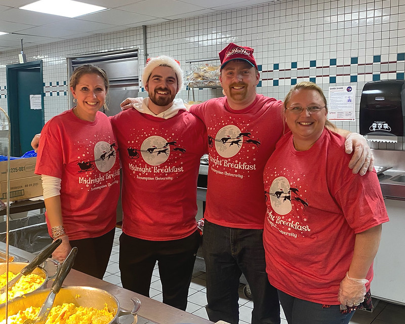 Assumption staff wearing red "Midnight Breakfast" T-shirts