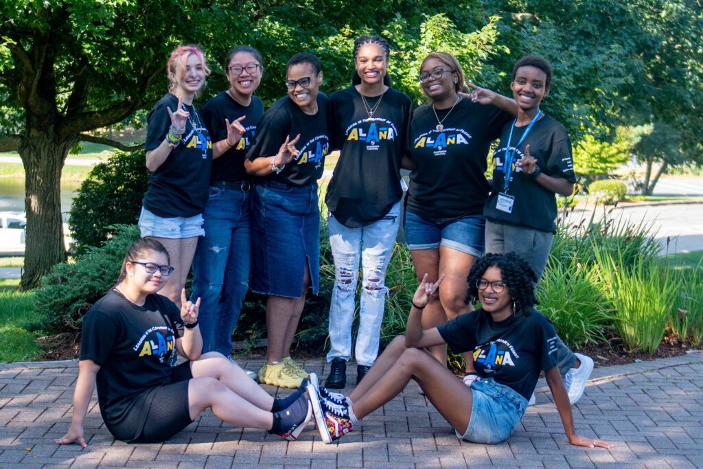 Students in the ALANA network gather and make the greyhound symbol. 