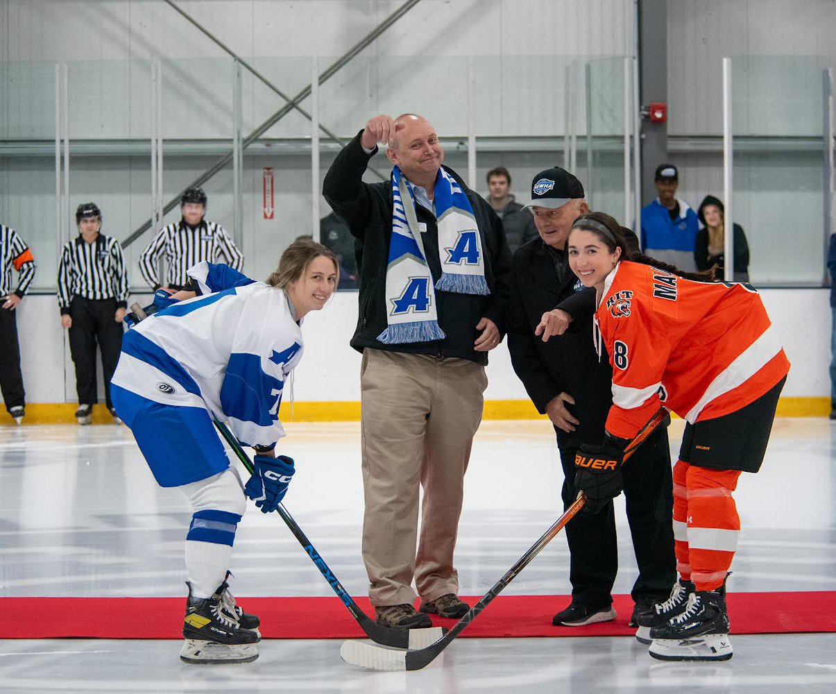 President Greg Weiner drops the ceremonious puck to start the first game in AU women's ice hockey history