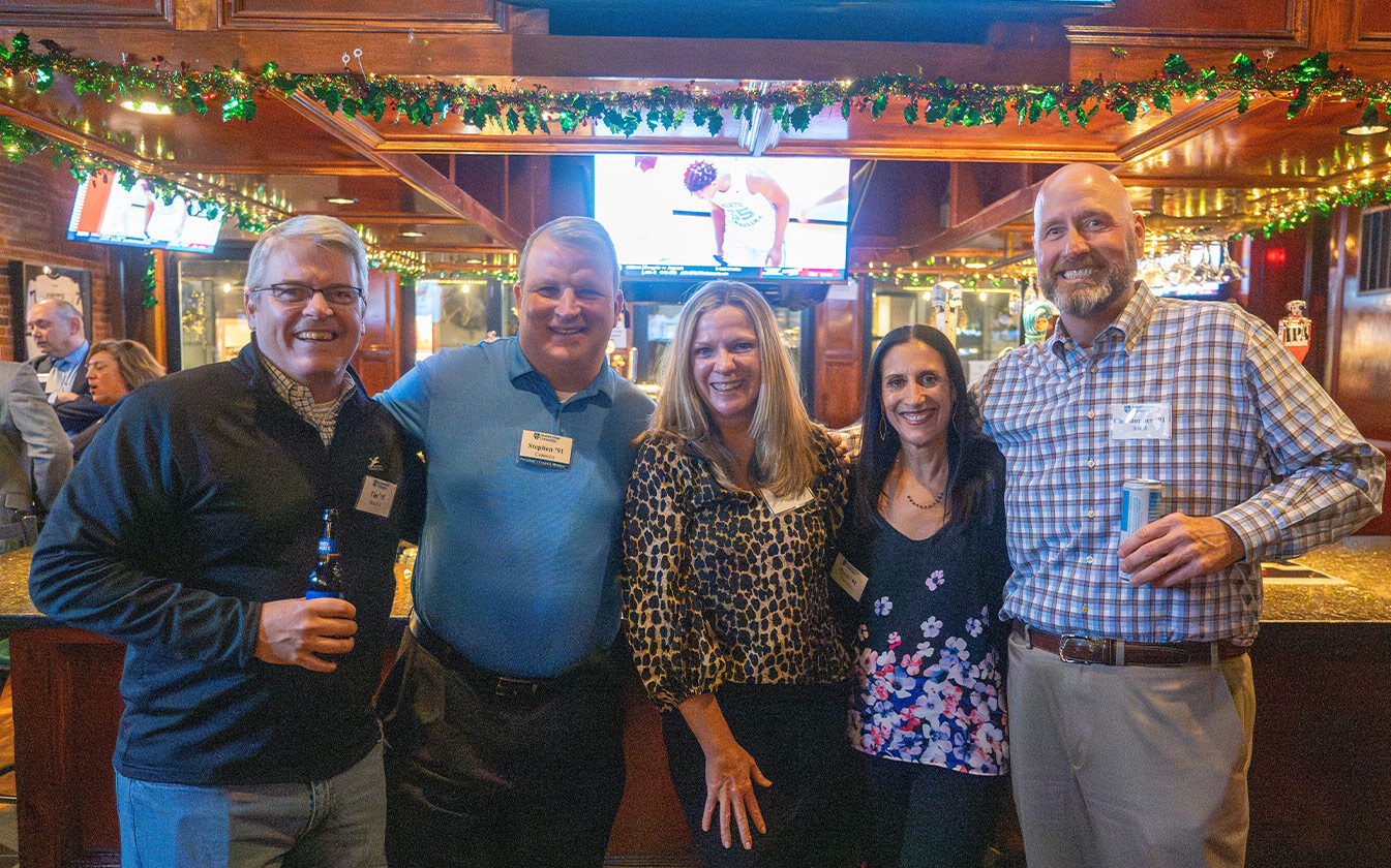 A group of Assumption University alumni attend an alumni event.