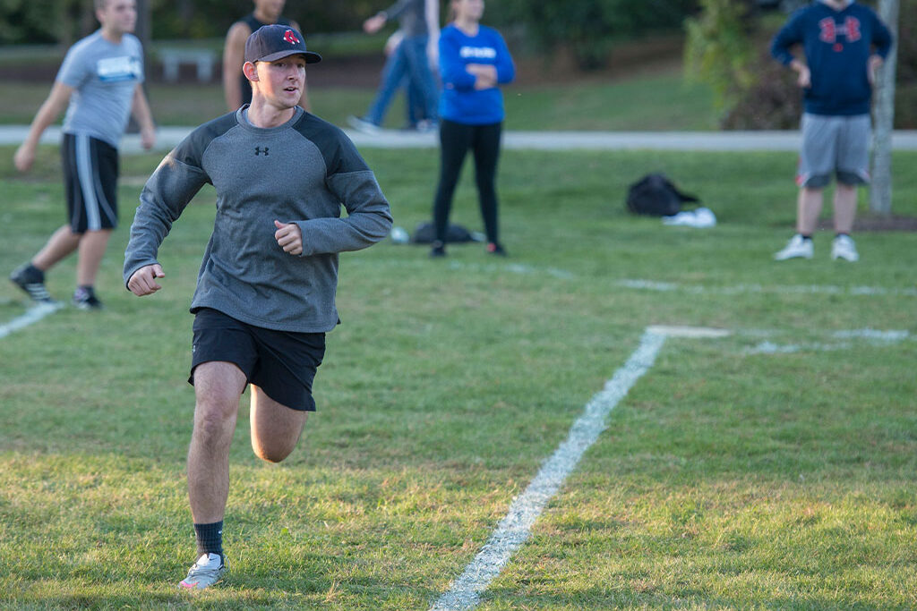 Assumption student running during a kickball game