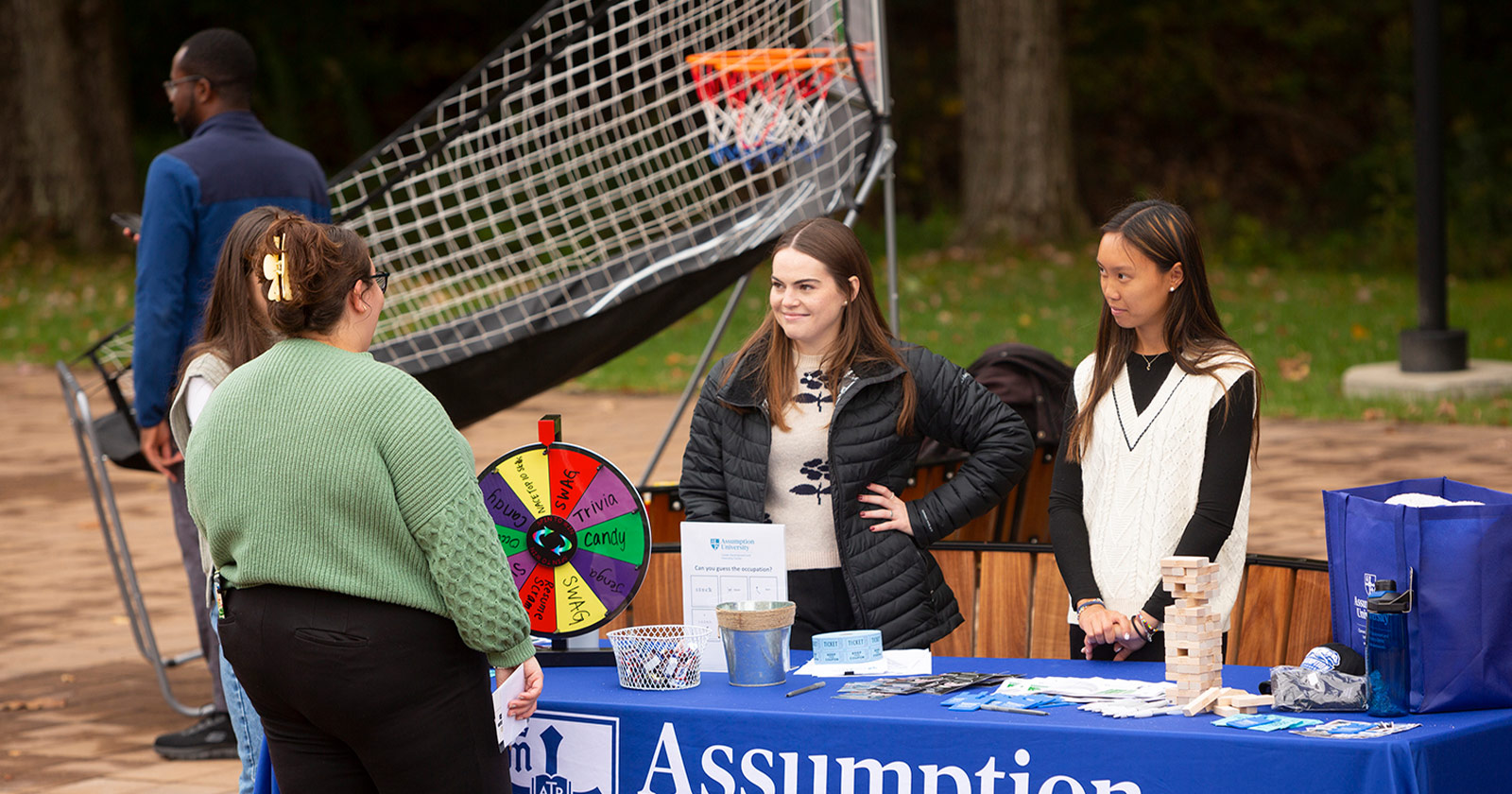 Two students work at an Assumption University event.