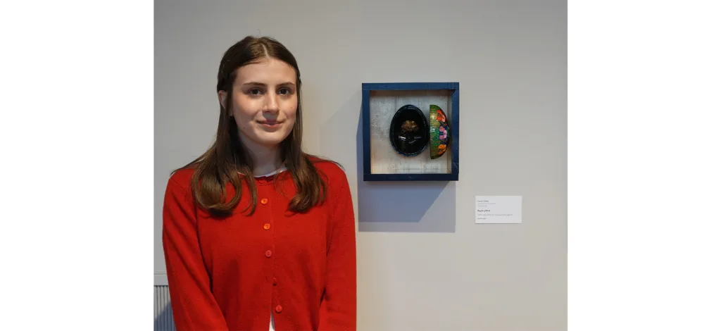 Student Lauren Haley '24 with her art "Regalia of Birth"