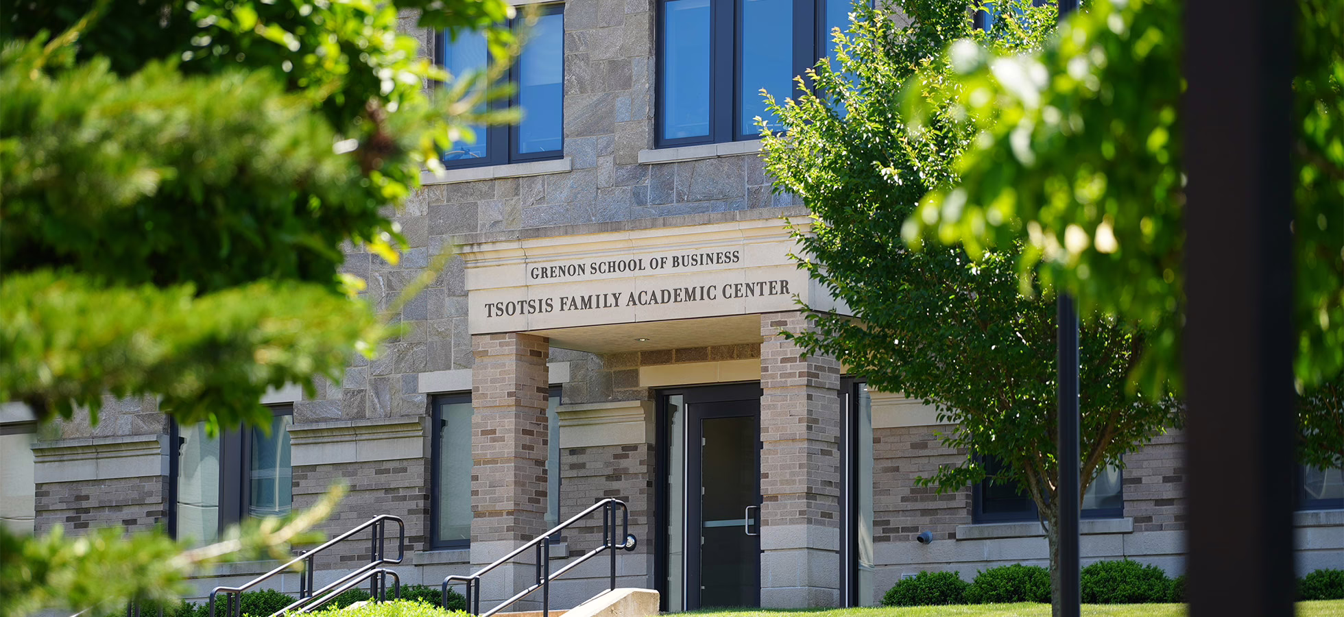 The Tsotsis Family Academic Center, housing the Grenon School of Business, is shown.
