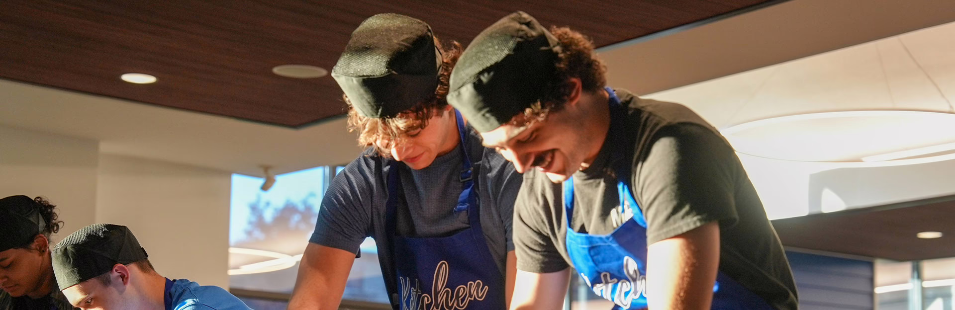 Assumption students participating in a cooking class at Taylor Dining Hall