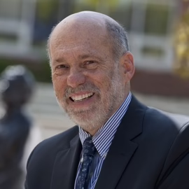 Headshot of Micheál J. Kelly, Ph.D. ’70